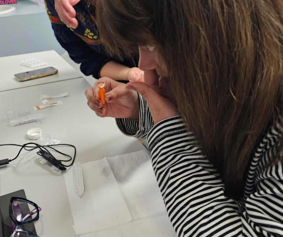 Woman inserting mini-scleral lens into eye