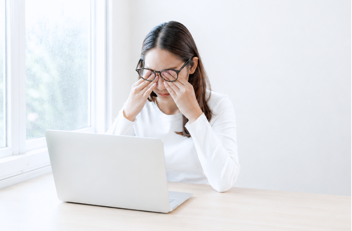 Woman experiencing dry eye while using computer