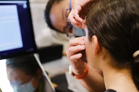 Contact lens being fitted to eye in ACO clinic